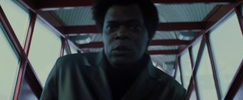 Movie still from “Unbreakable” (2000), directed by M. Night Shyamalan – A person wearing a suit and tie; Close Up shot, Low angle