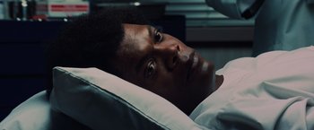 Movie still from “Unbreakable” (2000), directed by M. Night Shyamalan – A person laying in a hospital bed; Close Up shot, Low angle