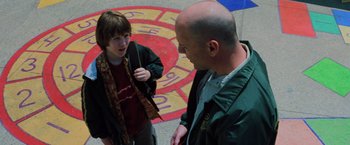 Movie still from “Unbreakable” (2000), directed by M. Night Shyamalan – A man and a young boy standing next to each other; Medium shot, Over the shoulder angle