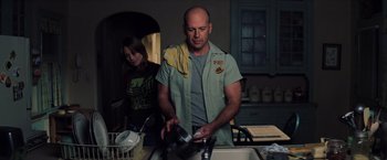 Movie still from “Unbreakable” (2000), directed by M. Night Shyamalan – A man and a woman in a kitchen preparing a meal; Medium shot, Low angle