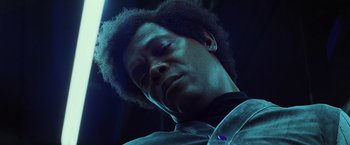 Movie still from “Unbreakable” (2000), directed by M. Night Shyamalan – A person wearing headphones; Close Up shot, Low angle