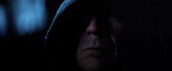 Movie still from “Unbreakable” (2000), directed by M. Night Shyamalan – A person wearing a hooded shirt; Extreme Close Up shot, Low angle