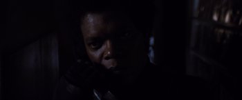 Movie still from “Unbreakable” (2000), directed by M. Night Shyamalan – A man's face in the dark; Close Up shot, Low angle