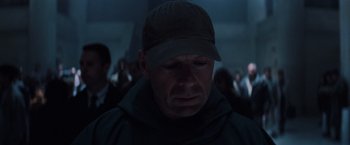 Movie still from “Unbreakable” (2000), directed by M. Night Shyamalan – A man with a hat is looking down; Close Up shot, Low angle