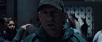 Movie still from “Unbreakable” (2000), directed by M. Night Shyamalan – A person wearing a hat; Close Up shot, Over the shoulder angle