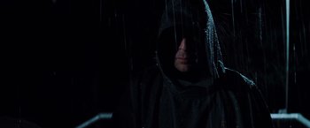 Movie still from “Unbreakable” (2000), directed by M. Night Shyamalan – A man in a black hooded jacket standing in the rain; Close Up shot, Low angle