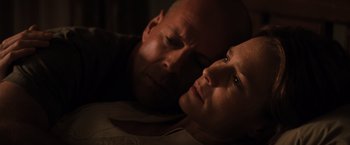 Movie still from “Unbreakable” (2000), directed by M. Night Shyamalan – A man and a woman laying on a bed with their eyes closed; Close Up shot, Low angle
