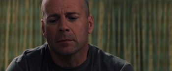 Movie still from “Unbreakable” (2000), directed by M. Night Shyamalan – A person wearing a t - shirt; Close Up shot, Low angle