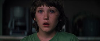 Movie still from “Unbreakable” (2000), directed by M. Night Shyamalan – A child with a green shirt; Close Up shot, Over the shoulder angle