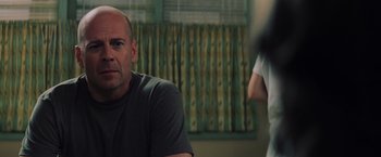 Movie still from “Unbreakable” (2000), directed by M. Night Shyamalan – A man sitting in front of another man in front of a window; Close Up shot, Over the shoulder angle