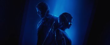 Movie still from “Uncharted” (2022), directed by Ruben Fleischer – A man and a woman standing side by side in the dark; Close Up shot, Over the shoulder angle