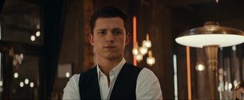 Movie still from “Uncharted” (2022), directed by Ruben Fleischer – A man in a vest and a white dress shirt; Close Up shot, Over the shoulder angle