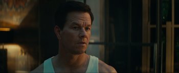 Movie still from “Uncharted” (2022), directed by Ruben Fleischer – A person wearing a tank top; Close Up shot, Over the shoulder angle