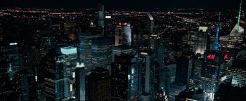 Movie still from “Uncharted” (2022), directed by Ruben Fleischer – A view of a city at night from a helicopter; Extreme Wide shot, High angle