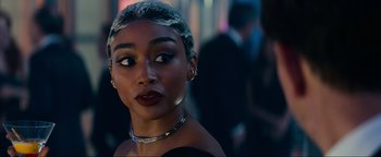 Movie still from “Uncharted” (2022), directed by Ruben Fleischer – A person wearing a necklace; Close Up shot, Over the shoulder angle