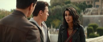 Movie still from “Uncharted” (2022), directed by Ruben Fleischer – A group of people standing next to each other near a body of water; Medium shot, Over the shoulder angle