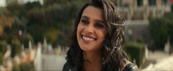 Movie still from “Uncharted” (2022), directed by Ruben Fleischer – A person with a smile on their face; Close Up shot, Over the shoulder angle