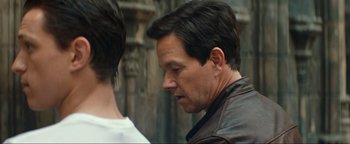 Movie still from “Uncharted” (2022), directed by Ruben Fleischer – A person wearing a leather jacket; Close Up shot, Over the shoulder angle