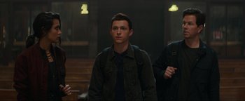 Movie still from “Uncharted” (2022), directed by Ruben Fleischer – A man standing in front of a crowd of onlookers; Medium shot, Over the shoulder angle