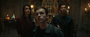 Movie still from “Uncharted” (2022), directed by Ruben Fleischer – A group of people standing next to each other in a room; Close Up shot, Low angle