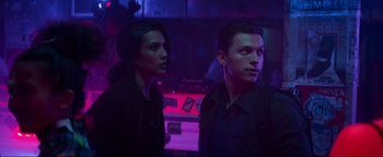 Movie still from “Uncharted” (2022), directed by Ruben Fleischer – Two people standing in a dark room at night; Medium shot, Low angle