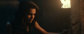 Movie still from “Uncharted” (2022), directed by Ruben Fleischer – A beautiful young woman with long dark hair; Close Up shot, High angle