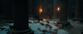 Movie still from “Uncharted” (2022), directed by Ruben Fleischer – A couple of people that are standing in the dirt; Wide shot, High angle