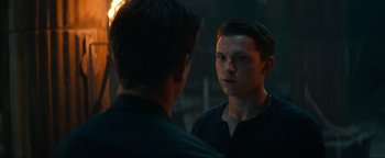 Movie still from “Uncharted” (2022), directed by Ruben Fleischer – A man looking at himself in the mirror; Close Up shot, Over the shoulder angle