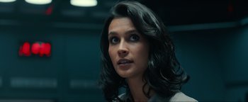 Movie still from “Uncharted” (2022), directed by Ruben Fleischer – A person with long black hair; Close Up shot, Over the shoulder angle