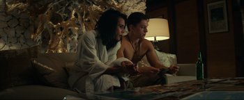 Movie still from “Uncharted” (2022), directed by Ruben Fleischer – A couple of men sitting on top of a bed next to each other; Medium shot, High angle