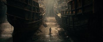Movie still from “Uncharted” (2022), directed by Ruben Fleischer – A man standing in the middle of a tunnel; Extreme Wide shot, High angle