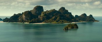Movie still from “Uncharted” (2022), directed by Ruben Fleischer – A large body of water surrounded by mountains; Extreme Wide shot, High angle
