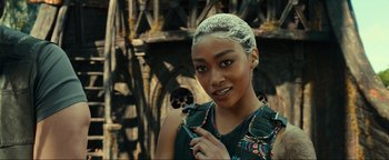 Movie still from “Uncharted” (2022), directed by Ruben Fleischer – A beautiful young woman with a white hair wig; Close Up shot, Over the shoulder angle