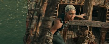 Movie still from “Uncharted” (2022), directed by Ruben Fleischer – An image of a woman in the woods; Medium shot, High angle