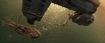 Movie still from “Uncharted” (2022), directed by Ruben Fleischer – Two people diving off a boat into the ocean; Extreme Wide shot, Overhead angle