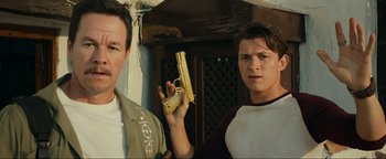 Movie still from “Uncharted” (2022), directed by Ruben Fleischer – Two young men standing next to each other; Close Up shot, Low angle