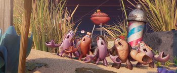 Movie still from “Under the Boardwalk” (2023), directed by David Soren – A group of people that are standing in the sand; Wide shot, Low angle