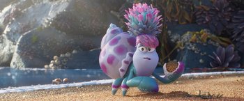 Movie still from “Under the Boardwalk” (2023), directed by David Soren – A blue and purple snail is sitting in the sand; Medium shot, Over the shoulder angle