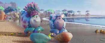 Movie still from “Under the Boardwalk” (2023), directed by David Soren – A couple of characters sitting on top of a sandy beach; Medium shot, Over the shoulder angle