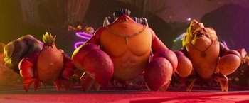 Movie still from “Under the Boardwalk” (2023), directed by David Soren – A large red creature with a gold chain around his neck; Wide shot, Low angle