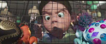 Movie still from “Under the Boardwalk” (2023), directed by David Soren – A child looking through a fence at a ball pit; Close Up shot, Low angle