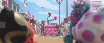 Movie still from “Under the Boardwalk” (2023), directed by David Soren – An animation of a man selling cotton candy on the beach; Wide shot, Over the shoulder angle