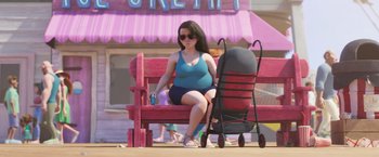 Movie still from “Under the Boardwalk” (2023), directed by David Soren – A woman sitting on top of a bench next to a baby stroller; Wide shot, Over the shoulder angle