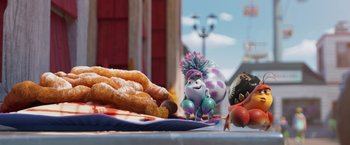 Movie still from “Under the Boardwalk” (2023), directed by David Soren – A table with a plate of food on top of it; Wide shot, High angle