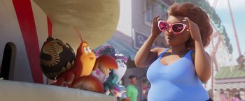 Movie still from “Under the Boardwalk” (2023), directed by David Soren – A woman standing next to a group of stuffed animals; Medium shot, Over the shoulder angle