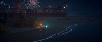 Movie still from “Under the Boardwalk” (2023), directed by David Soren – A beach at night with a ferris wheel in the background; Extreme Wide shot, High angle