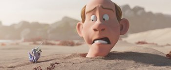 Movie still from “Under the Boardwalk” (2023), directed by David Soren – An animated head in the sand with a sad look on his face; Close Up shot, Low angle