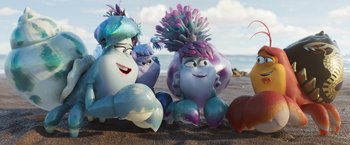 Movie still from “Under the Boardwalk” (2023), directed by David Soren – A couple of people sitting on top of a sandy beach; Wide shot, High angle