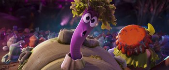 Movie still from “Under the Boardwalk” (2023), directed by David Soren – A slug with a plant in it's mouth; Close Up shot, Over the shoulder angle