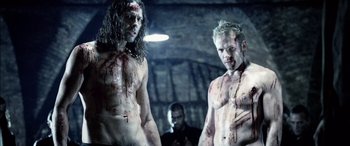 Movie still from “Underworld” (2003), directed by Len Wiseman – Two shirtless men with blood on their chests; Medium shot, Low angle